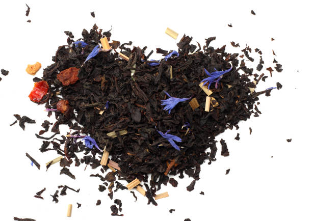 istock Aromatic black dry tea with petals isolated on white background top view 915995910