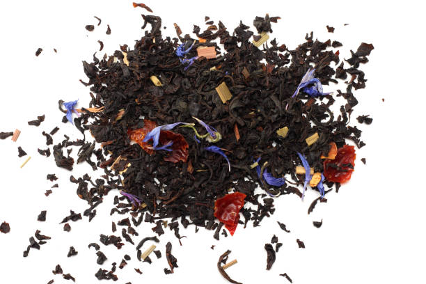 Aromatic black dry tea with petals isolated on white background top view