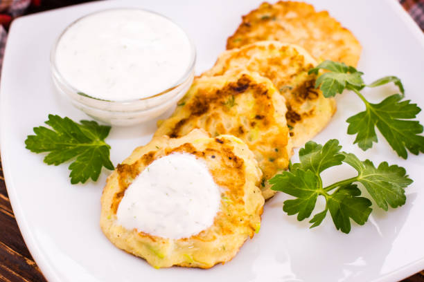 istock Pancakes from a zucchini, sauce and parsley 915996890