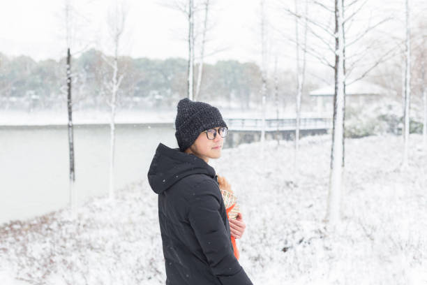 istock young man hugging his dog walking in park 915999082