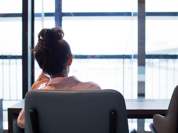 istock A woman are looking at windows, seem she is thinking something. 916008424