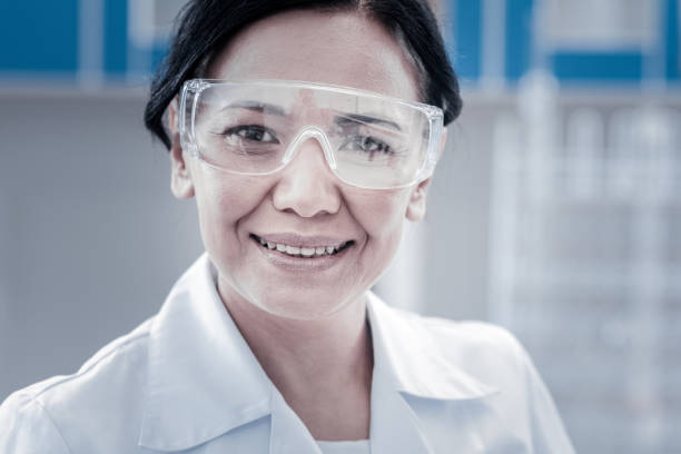 istock Cheerful female laboratory worker smiling into camera 916008742