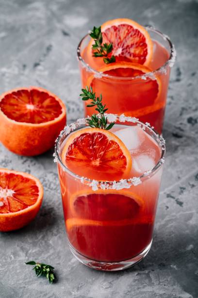 istock Blood Orange Margarita coctail with ice and thyme 916015840