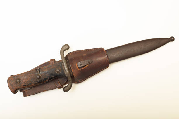 Close up view of vintage bayonet in scabbard aganist white background