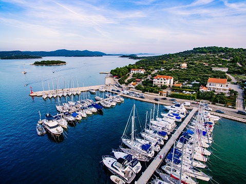 Aerial drone bird's eye view of small marina with boats and yachts docked in Croatia
