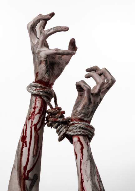 istock Hands bound,bloody hands, mud, rope, on a white background, isolated, kidnapping, zombie, demon 916018468