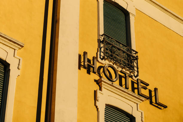 istock Hotel sign in yellow facade 916019914
