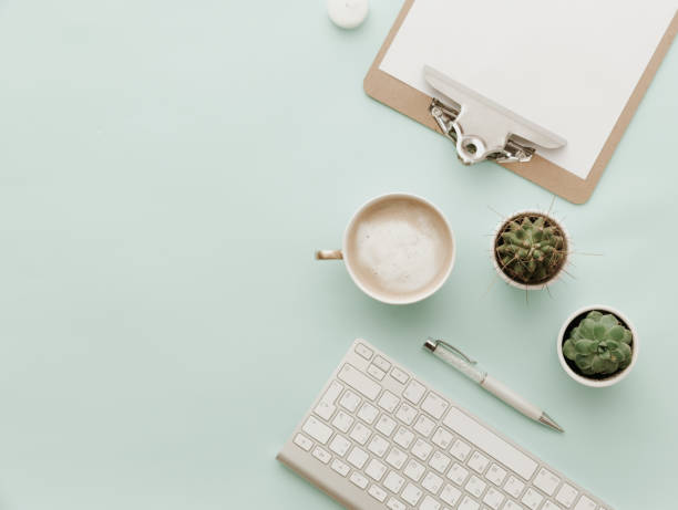 istock Minimalist Flat Lay Hipster Desktop With coffee latte, keyboard, clipboard and cactus 916020760
