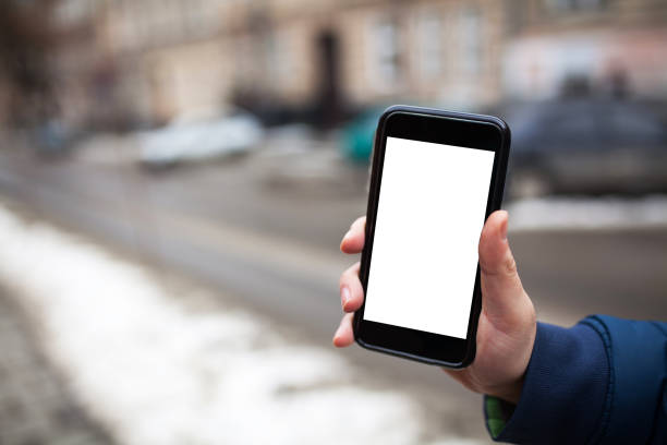 istock Man holding mobile phone with blank mock up screen 916024454
