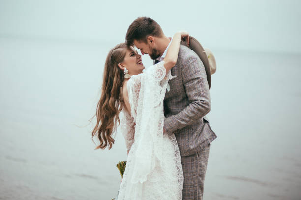 istock cheerful bride and groom in boho style hugging at lake 916024930