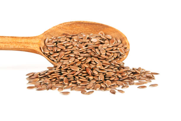 istock Wooden spoon with flax seeds isolated on white background 916028024