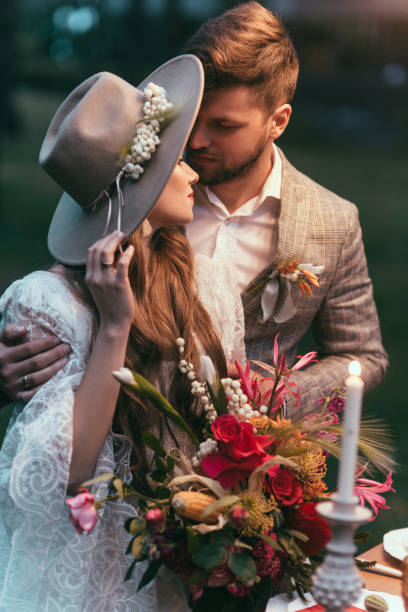 istock beautiful couple hugging and holding wedding bouquet 916028474