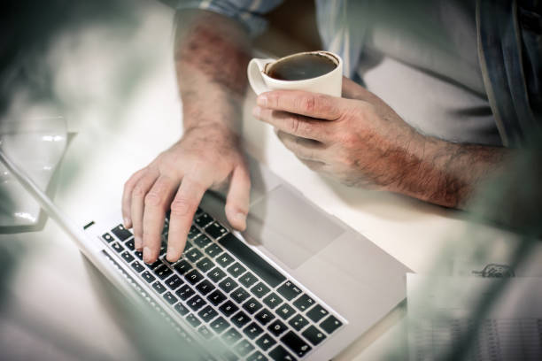 istock Working and holding cup of coffee. 916031924