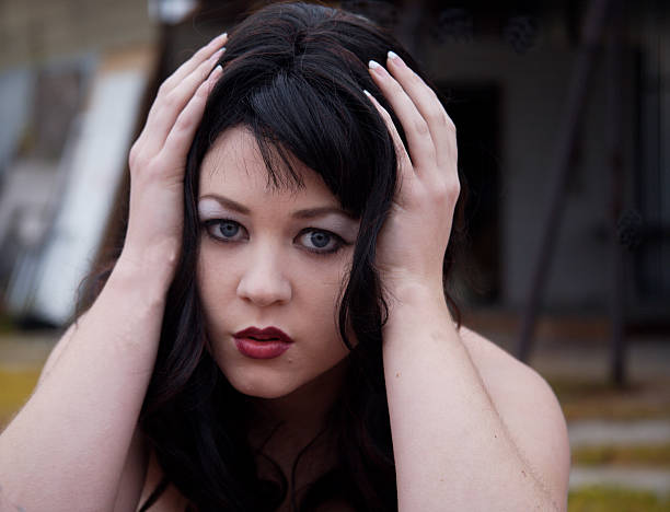 Young woman pondering a decision stock photo