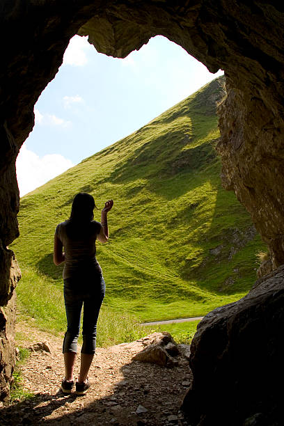 istock Girl in cave entrance looking out. 91603340