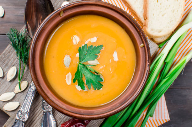 istock Pumpkin cream soup with pumpkin seeds  in bowl 916036098