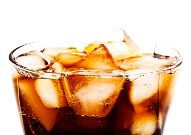 istock Cola in glass with ice cubes on white background 916039826
