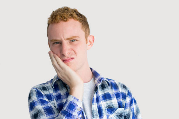 istock Disgusted Young Caucasian Man with Palm on Cheek 916039972