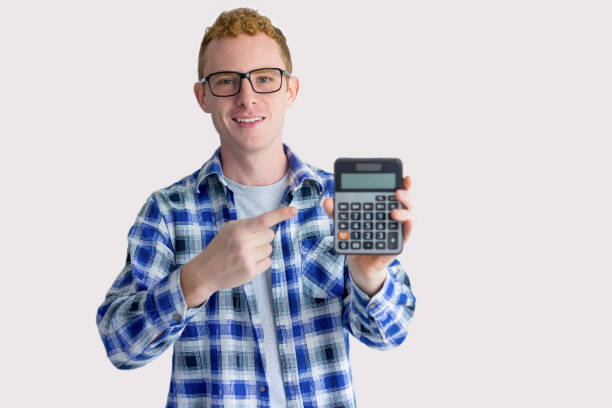 istock Excited Young Man Pointing at Calculator Screen 916039998