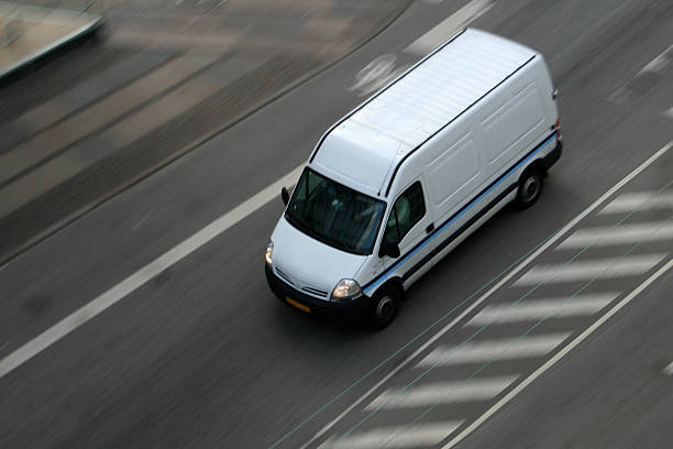 Delivery van moving on road stock photo