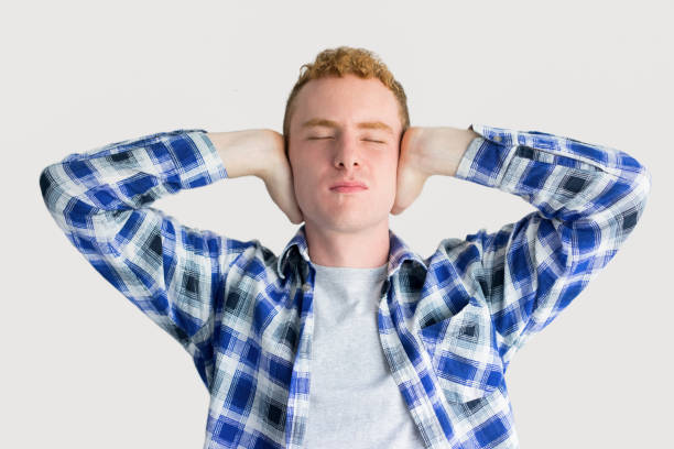 istock Tired Red Haired Guy Covering Ears with Palms 916040122