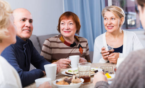 istock Mature friends are talking about life and drinking tea 916044682