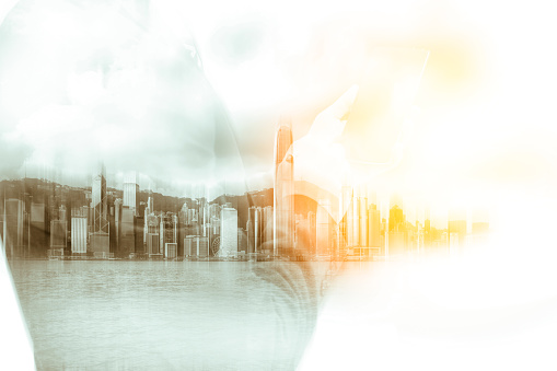 Double exposure of businessman and Hong Kong city view with sunlight