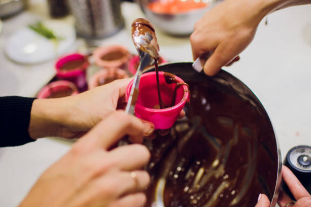 istock Woman preparing dough for chocolate pie on table close up 916048252