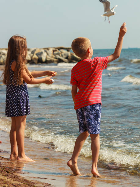 istock Kids playing outdoor on beach. 916048722