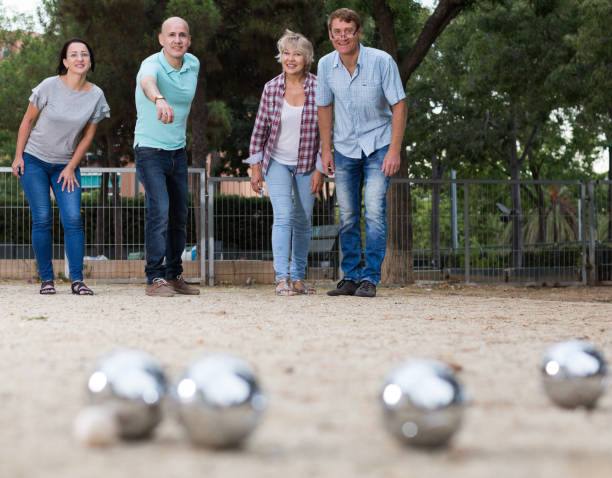 istock friendly mature couples playing petanque at leisure 916049124