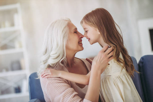 little girl with grandmother - grandmother action senior adult grandparent imagens e fotografias de stock