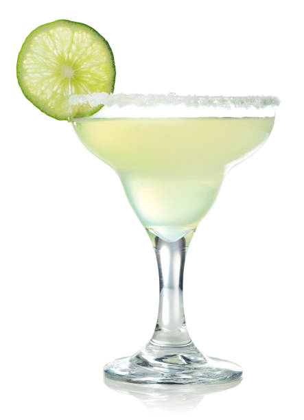 Classic margarita cocktail with lime Glass of classic margarita cocktail decorated with slice of lime isolated on white background margarita stock pictures, royalty-free photos & images
