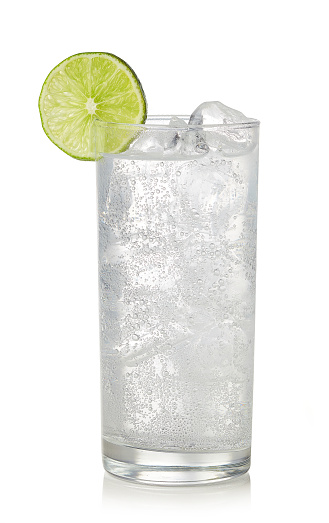 Glass of gin and tonic cocktail isolated on white background. Sparkling drink