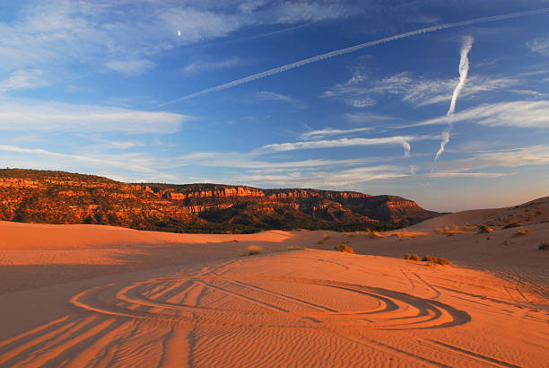 Circular tire tracks in desert sand dunes stock photo