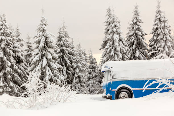 istock Blue bus parked in a snowy landscape. 916055536