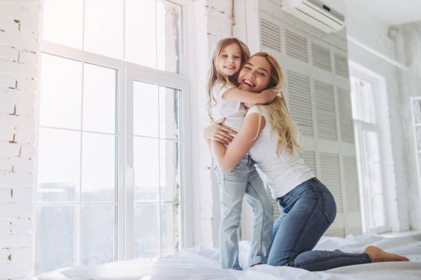 istock Mom and daughter having fun at home 916055556