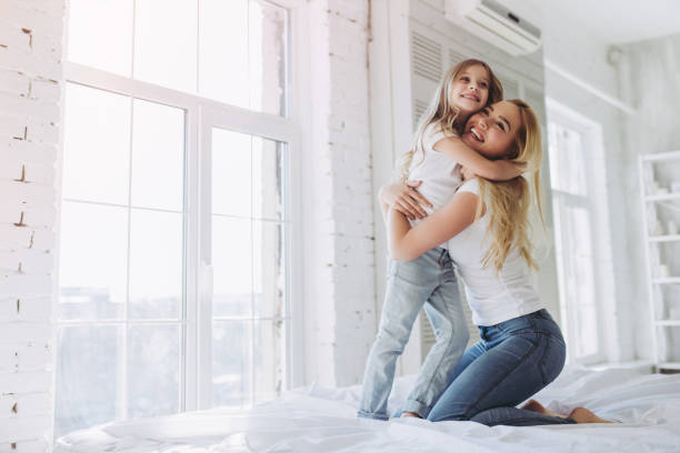 istock Mom and daughter having fun at home 916055566