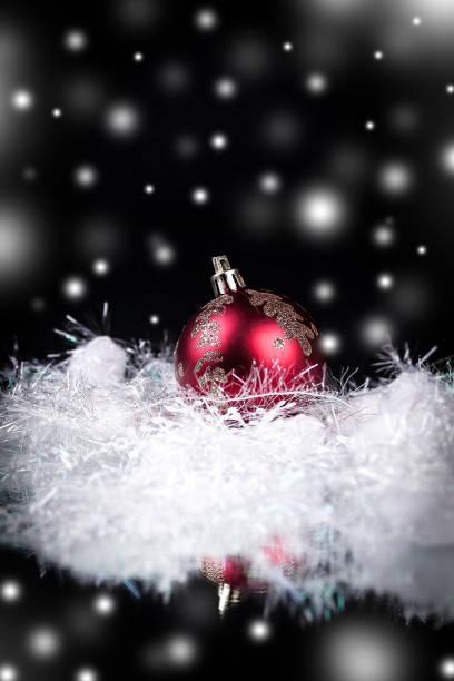 istock beautiful red Christmas ball on a black background 916056720