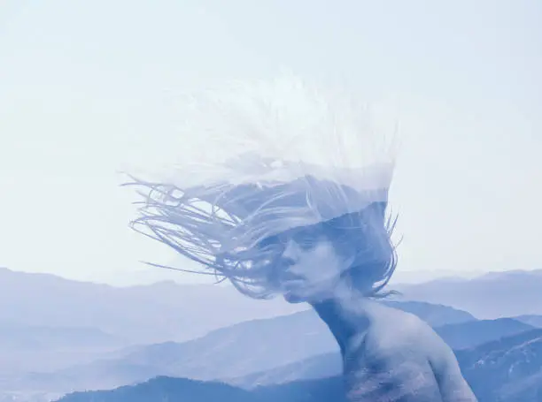 Photo of double exposure portrait of young girl and blue mountains