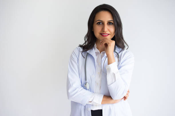 istock Smiling Pretty Female Doctor Touching Chin 916057926