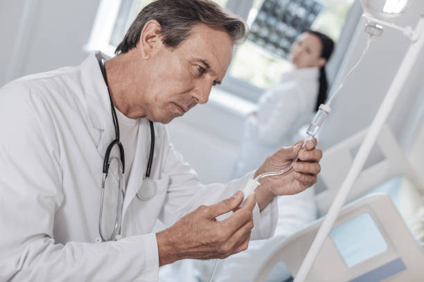istock Concentrated physician checking drop counter in hospital 916061320