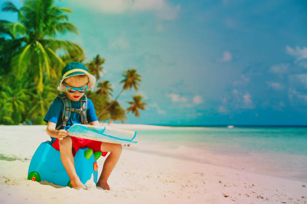 istock little boy travel on summer tropical beach 916064154