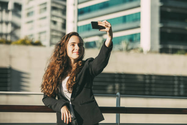 istock Intern taking selfie against business district 916064528
