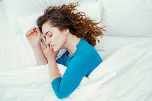 istock Middle-aged Beautiful Woman Sleeping in Bed 916064730