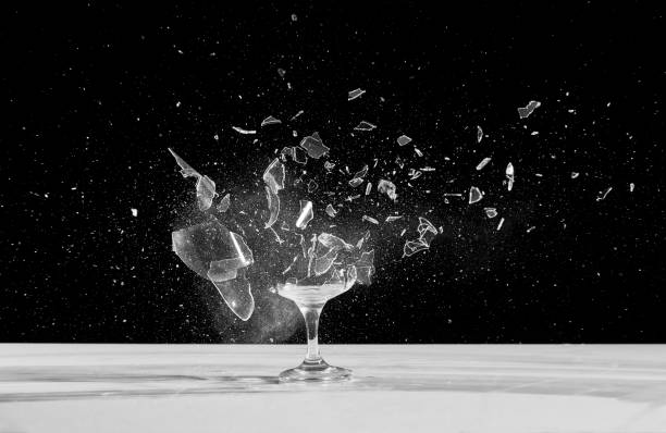dessert wine glass crashing The glass is placed in a dark room slow motion stock pictures, royalty-free photos & images