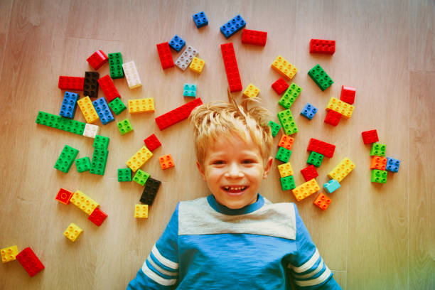 istock cute little boy love playing with plastic blocks 916068418