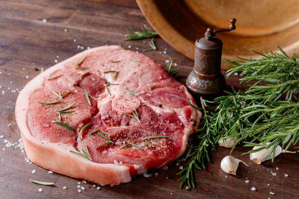 istock Raw pork with rosemary , salt and pepper. 916072504