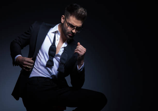istock man in tuxedo holds collar while sitting and looking down 916073336