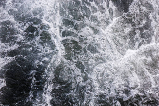 istock Sea waves raging and splashing, abstract bubbles background 916076664