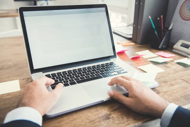 istock Hands of businessman using notebook computer at working desk in the office 916076770